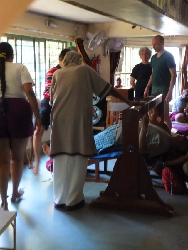 iyengar assisting setu bandha 3